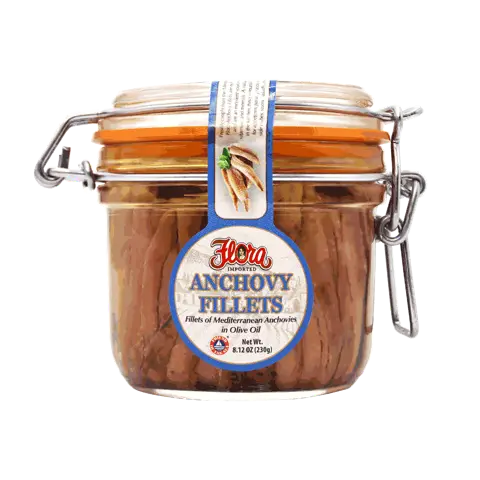 Hermetic glass jar of Flora Foods anchovy fillets in olive oil, 8.12 oz, showing preserved anchovies ready for culinary use.