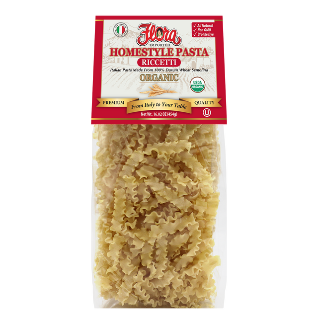 Organic Homestyle Riccetti pasta by Flora Foods, 16.02 oz, showing uncooked pasta in a bowl on a wooden surface.