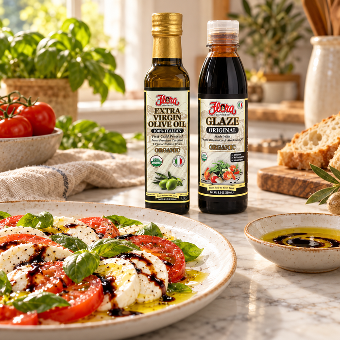 Original Flora organic olive oil and balsamic glaze with a finished Caprese salad and olive oil dipping dish